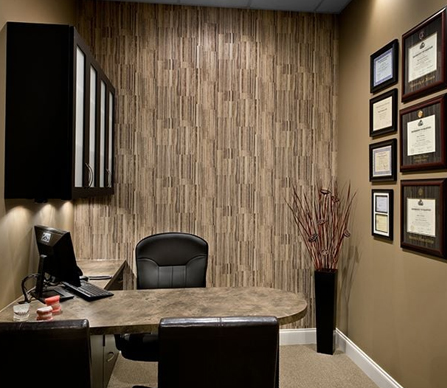 Professional dental office workspace with desk, chair, and modern textured wall decor