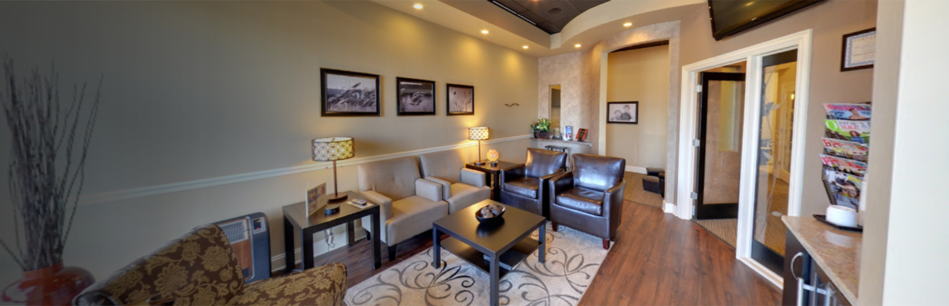Warm dental office waiting room with comfortable seating, modern décor, and welcoming atmosphere.