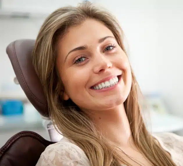 Smiling woman in dental chair at Nelson Ridge Family Dental office during examination.